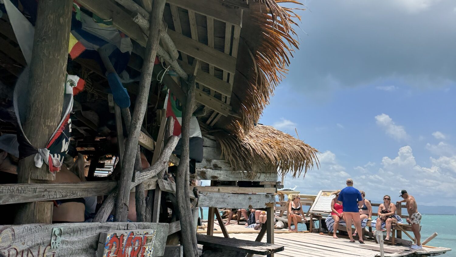 Floyd’s Pelican Bar, Jamaica: Everything You Need to Know Before You Go on a wooden water bar in the Caribbean Sea